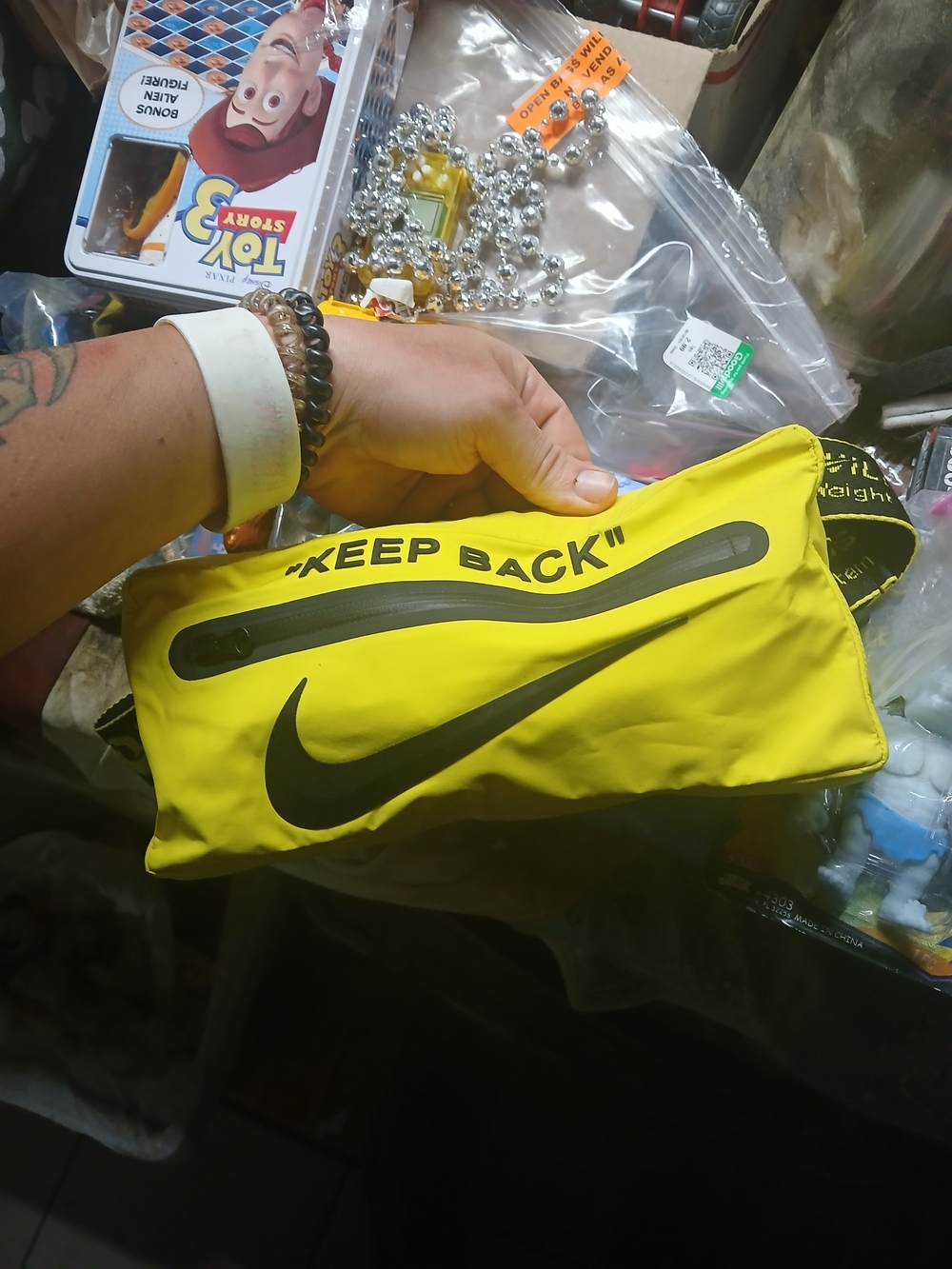 vibrant yellow Nike x Off-White belt bag featuring a bold "KEEP BACK" text acros